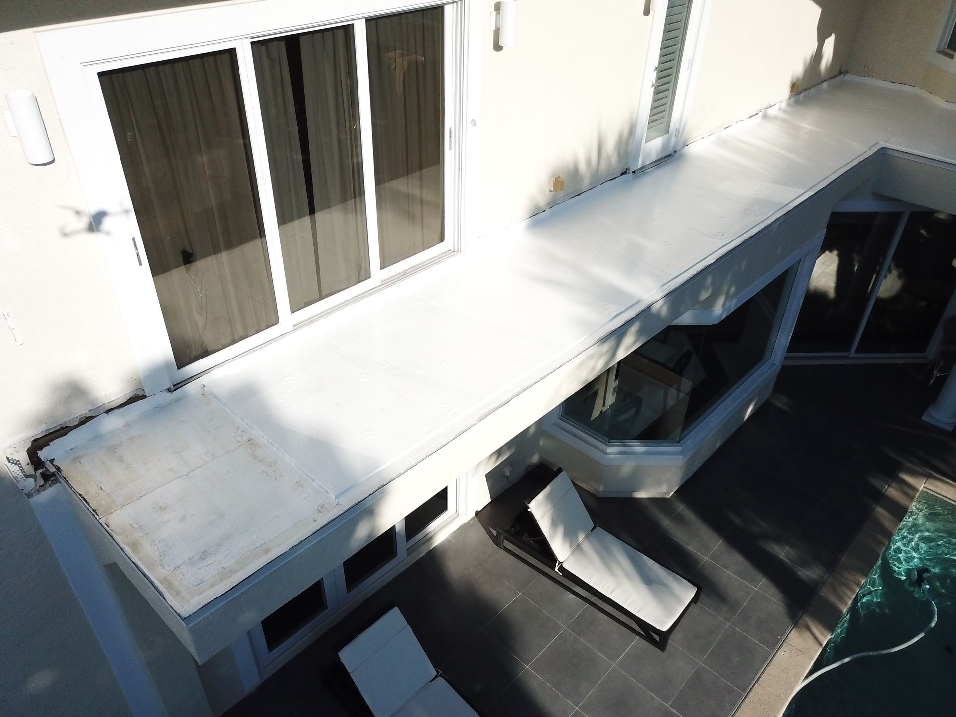 An aerial view of a house with a swimming pool