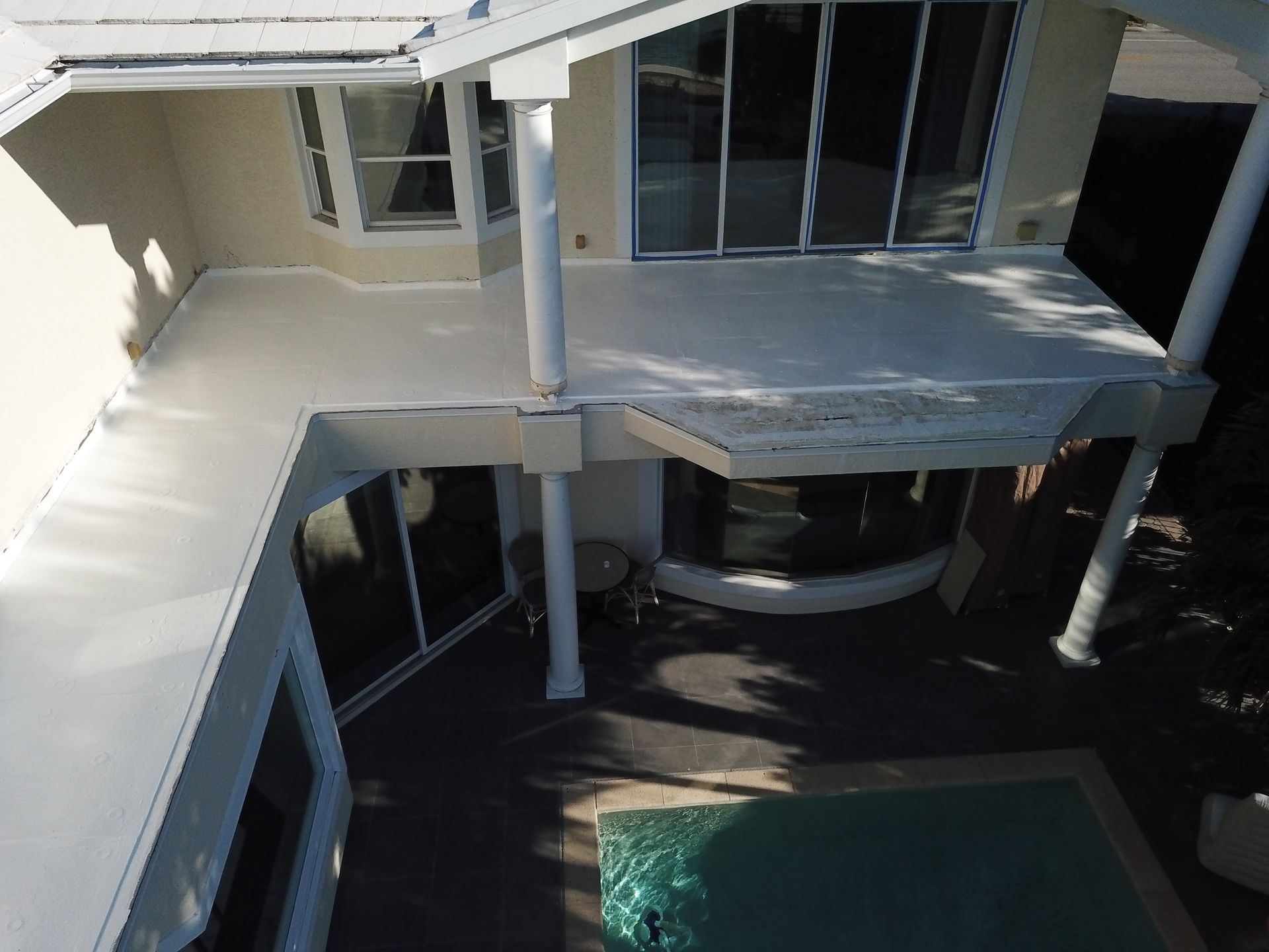 An aerial view of a house with a swimming pool