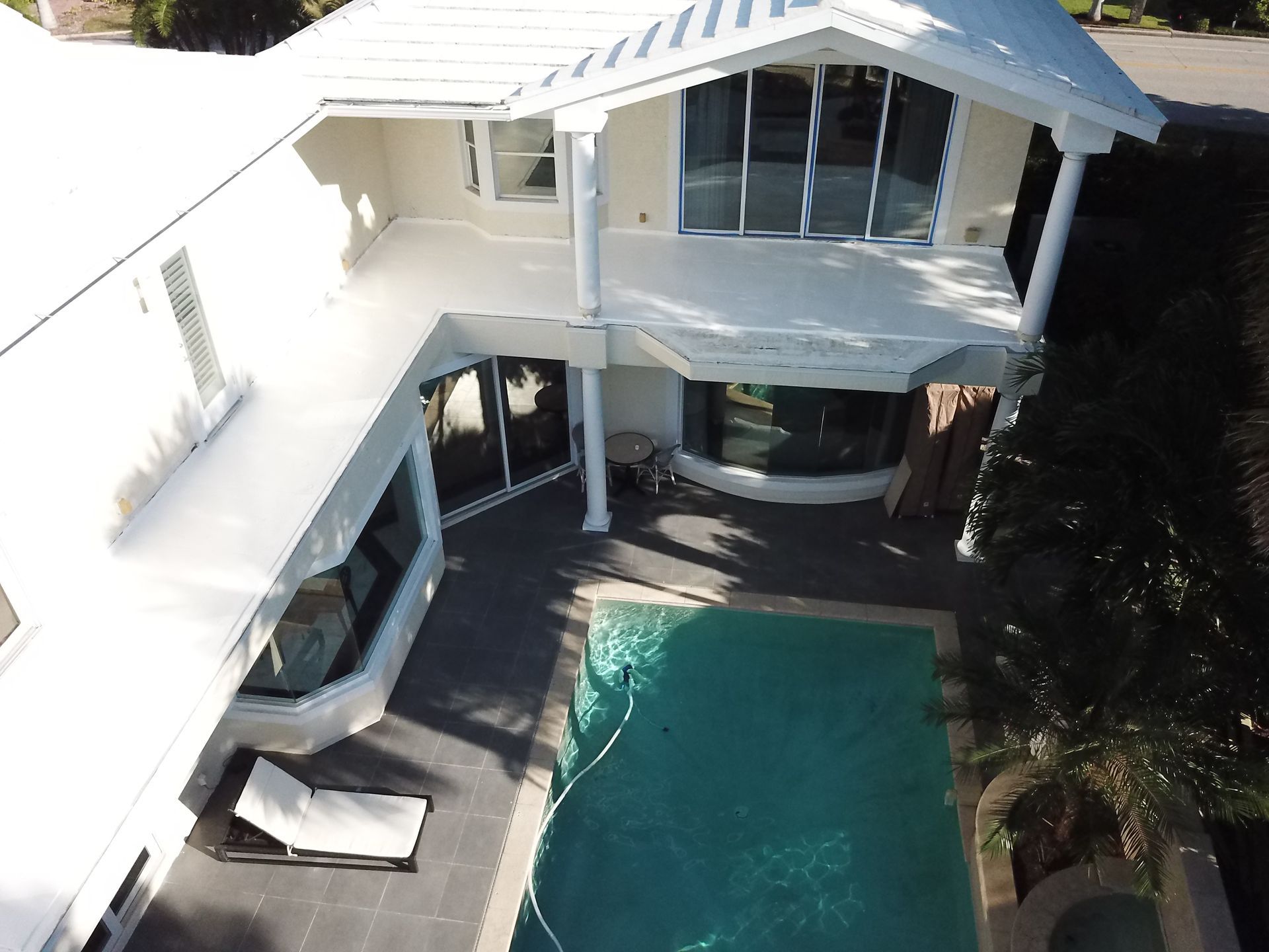 An aerial view of a house with a swimming pool