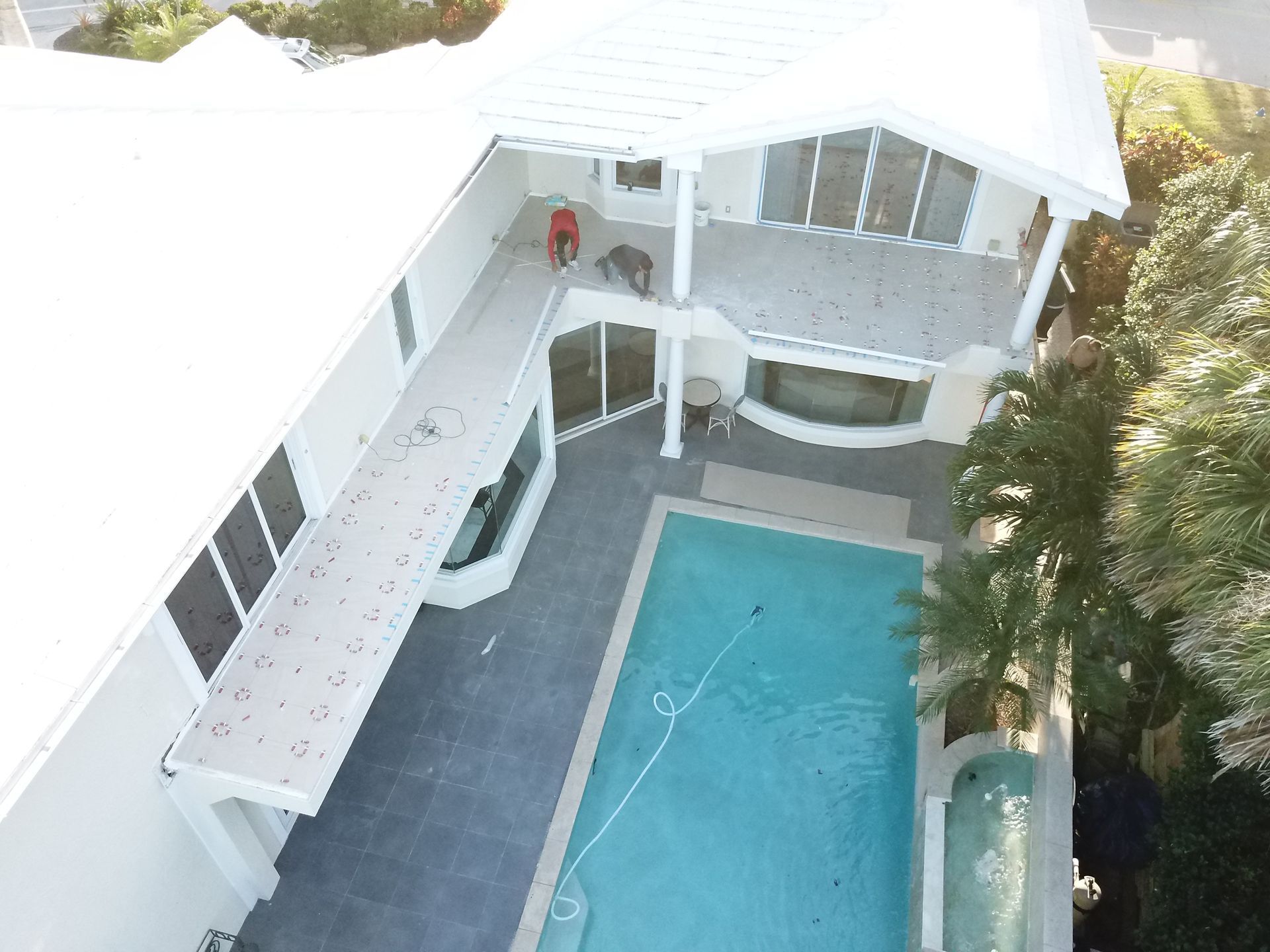An aerial view of a large house with a swimming pool