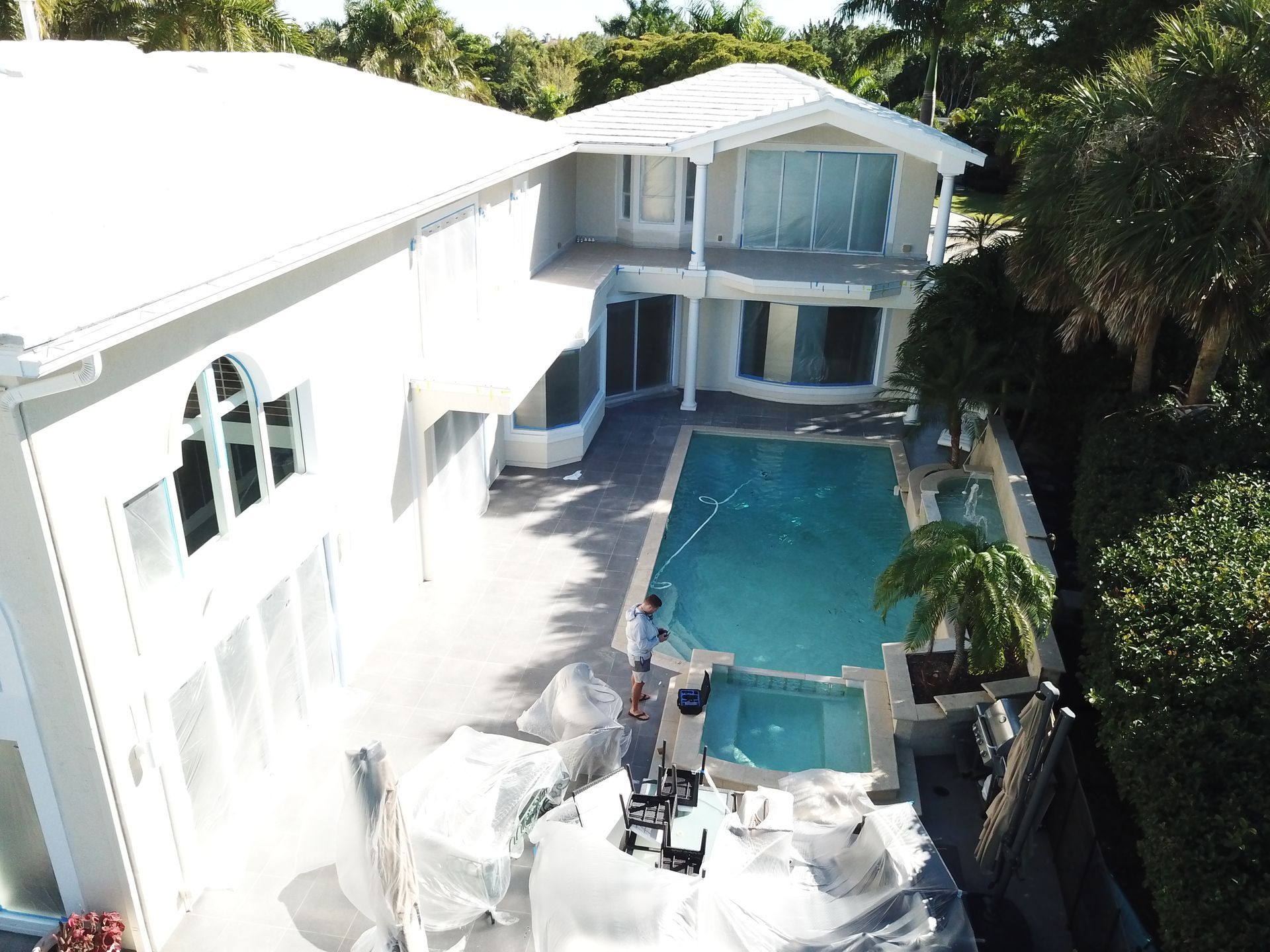 An aerial view of a house with a swimming pool