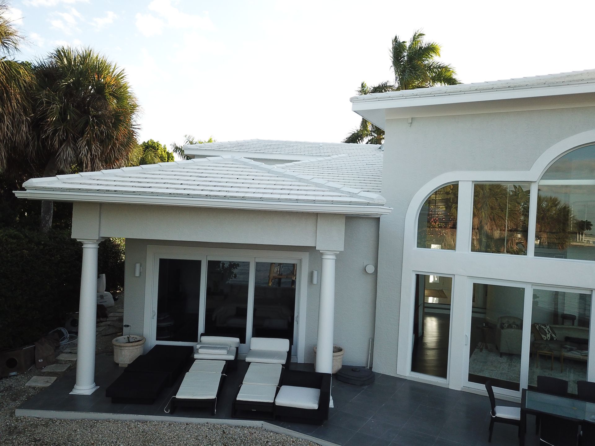 An aerial view of a house with a white roof