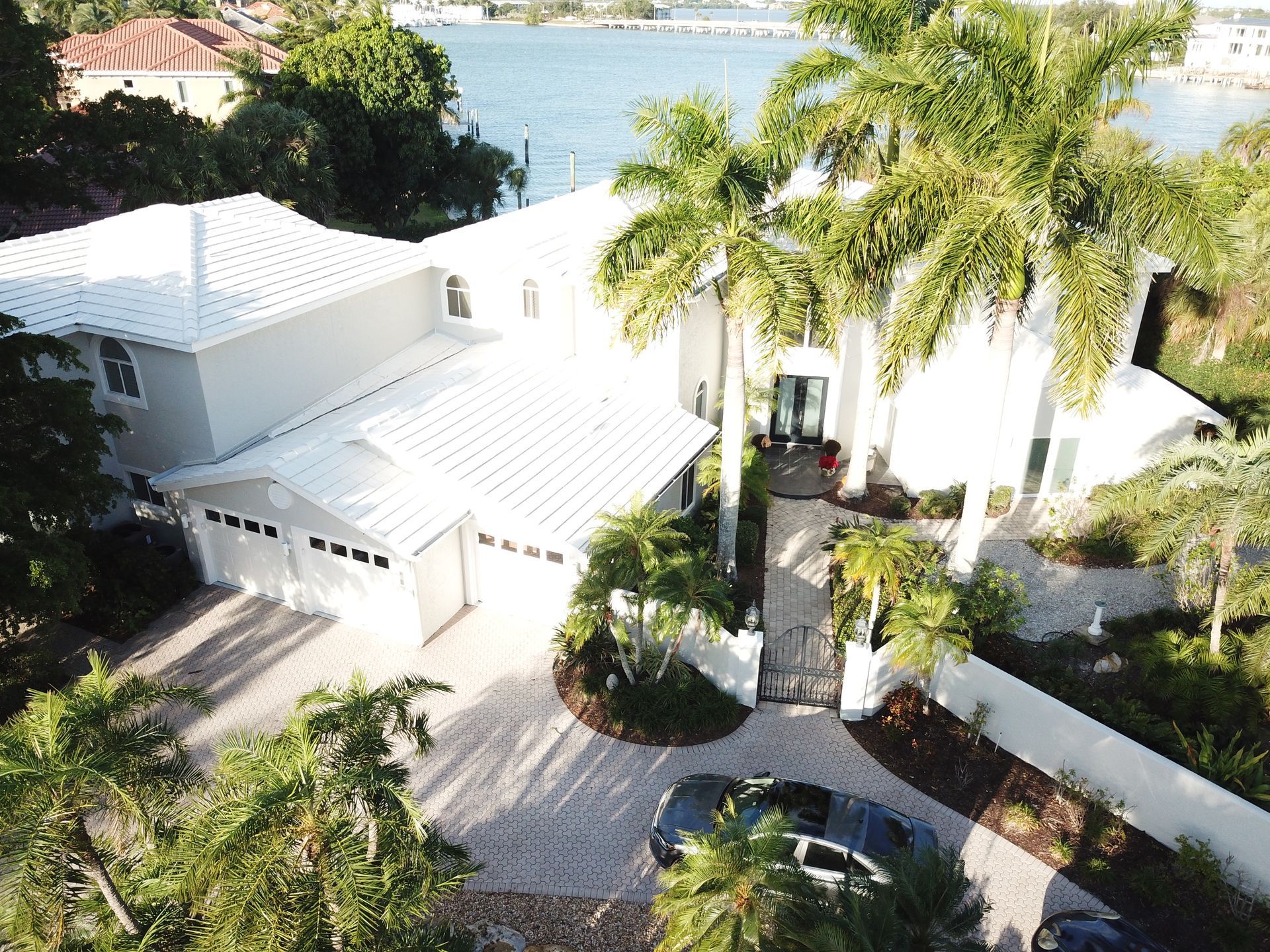 An aerial view of a house with a car parked in front of it
