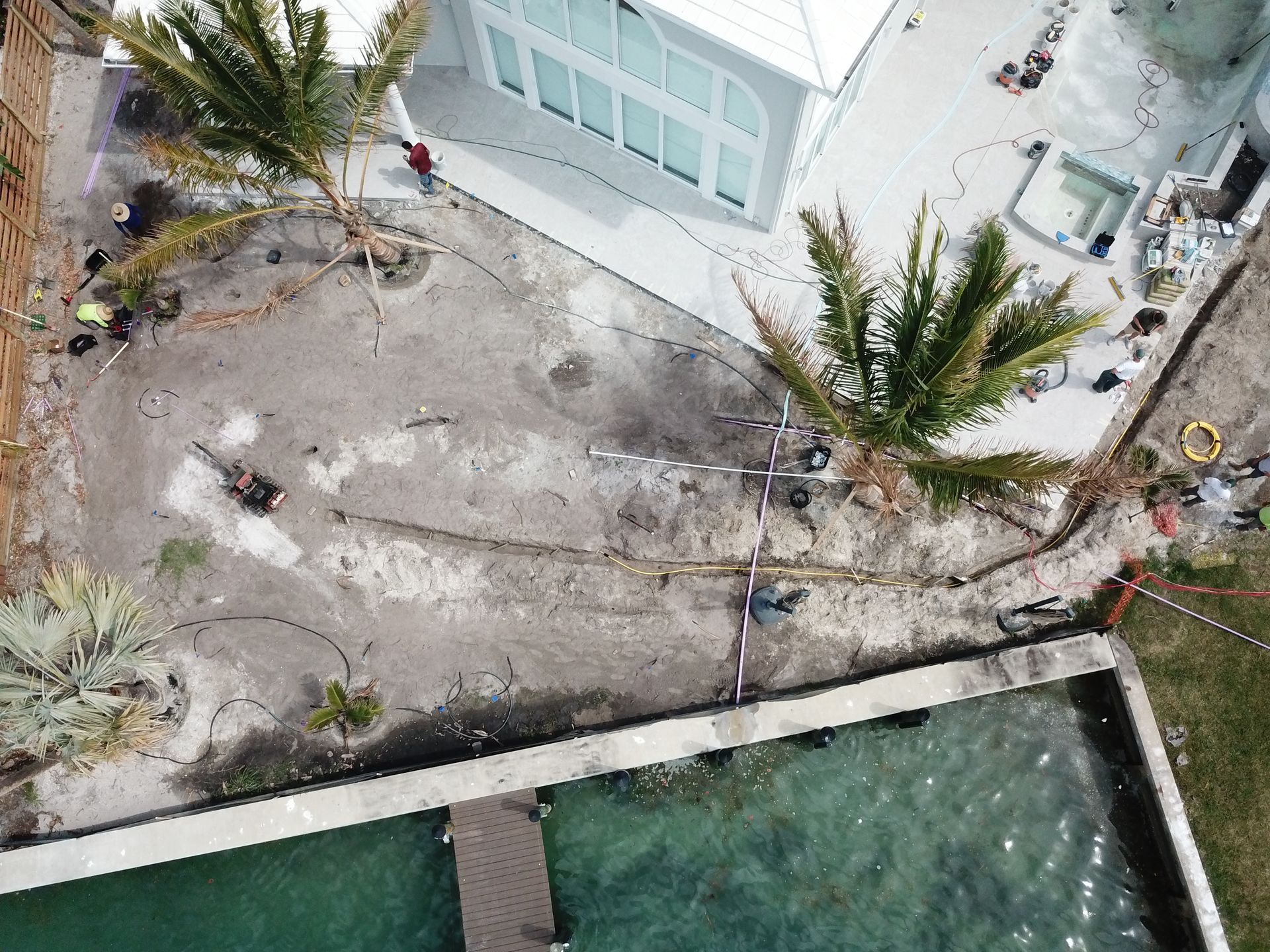 An aerial view of a house with a pool and palm trees