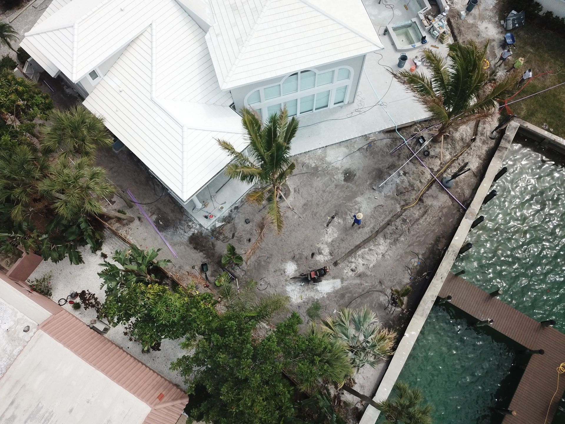 An aerial view of a house with a pool and palm trees