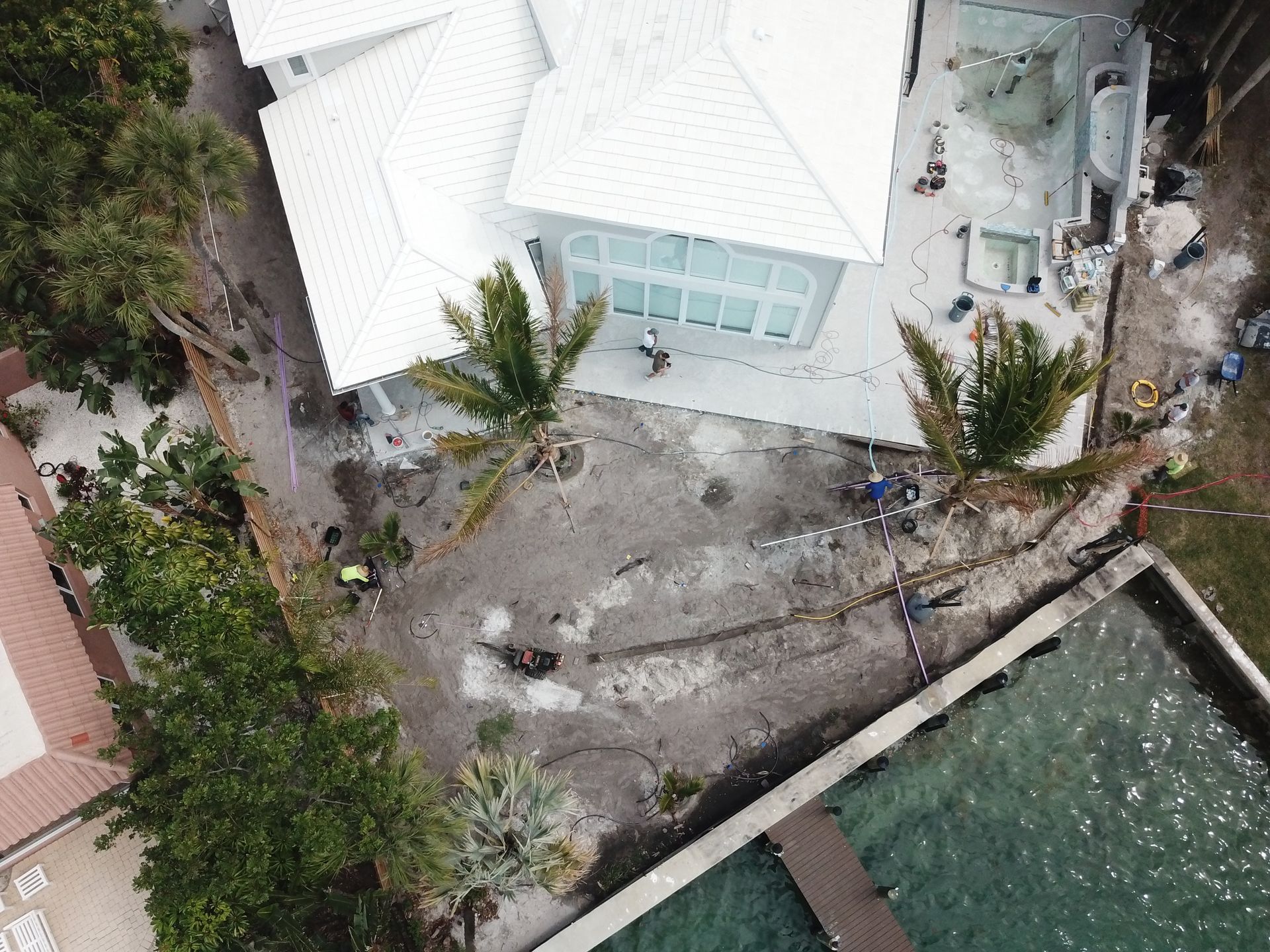 An aerial view of a house with a pool in front of it