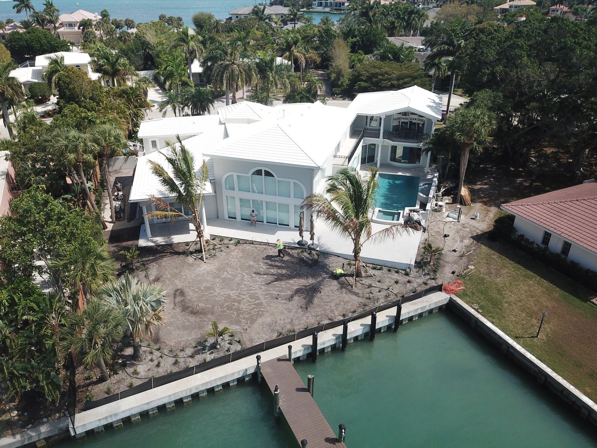 An aerial view of a house next to a body of water