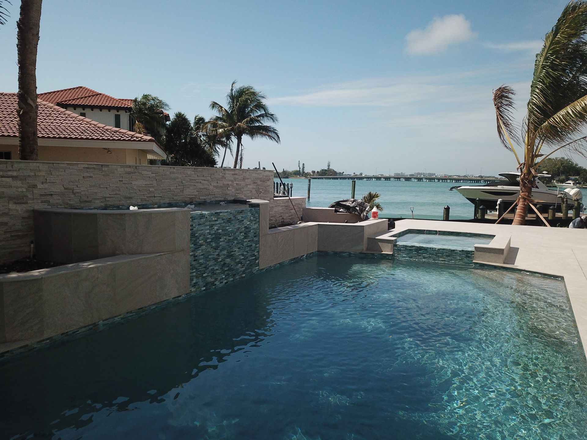 A large swimming pool with a view of the ocean