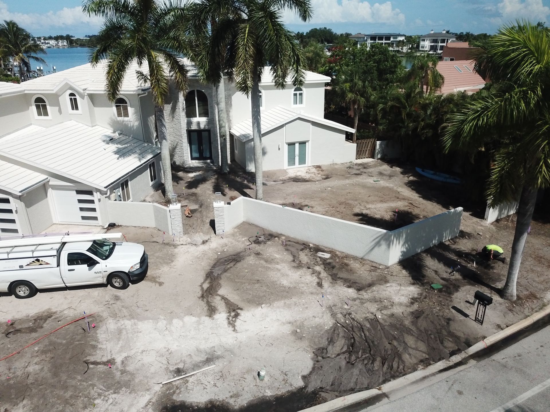 An aerial view of a house with a white truck parked in front of it