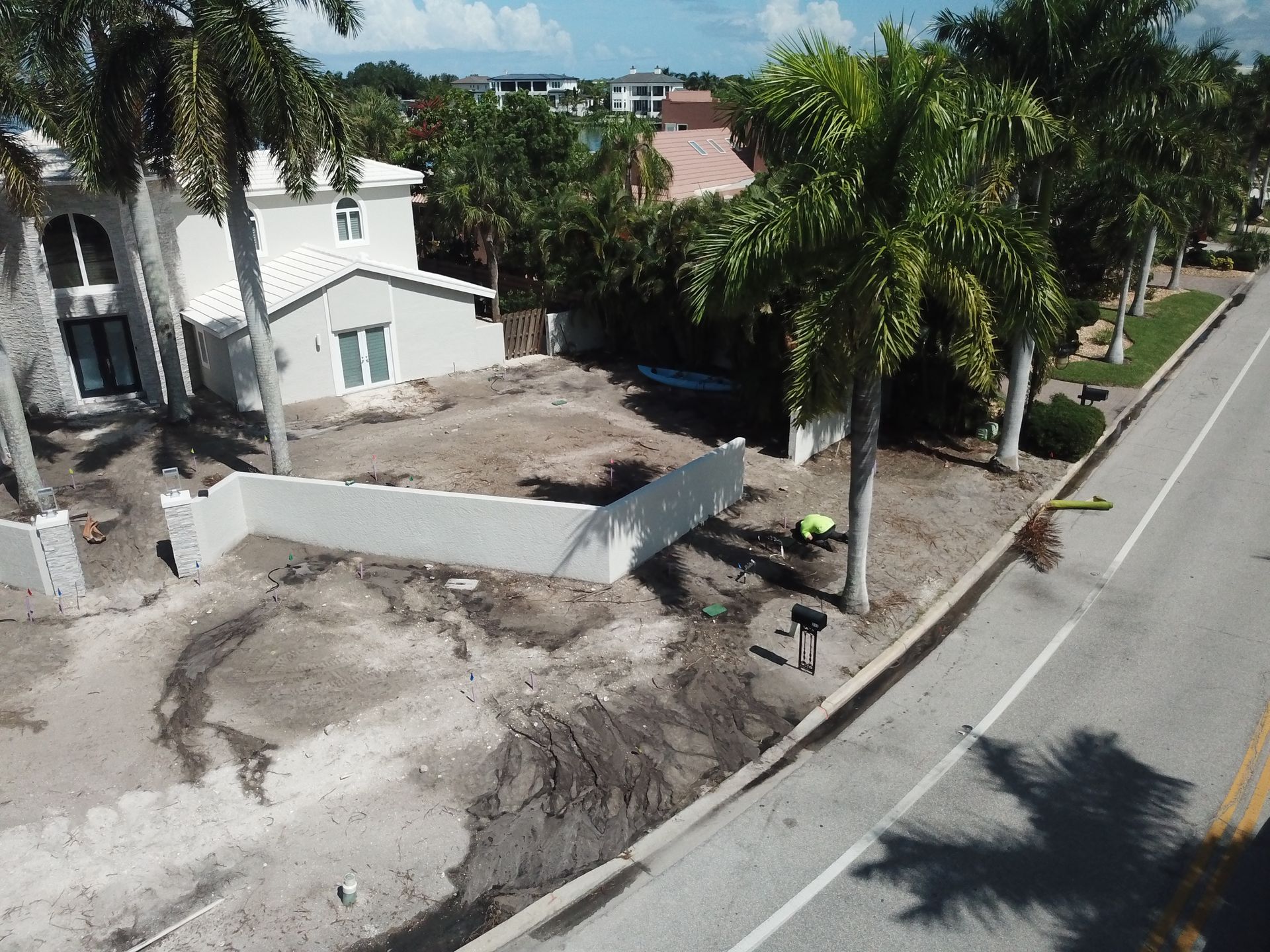 An aerial view of a house being built next to a road