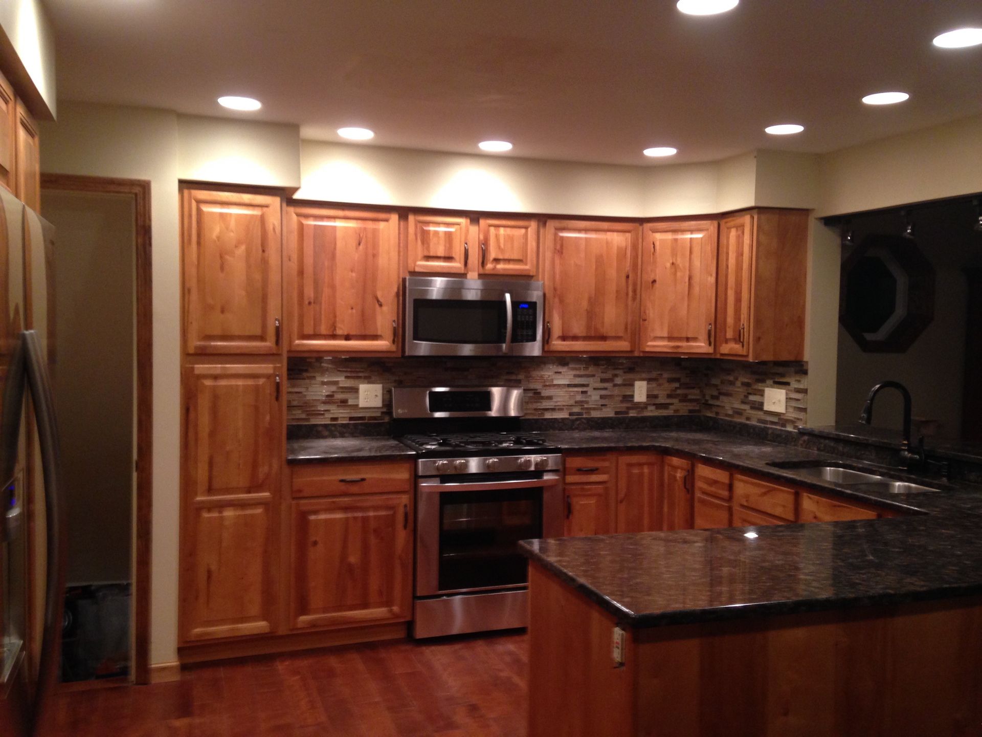 A kitchen with stainless steel appliances and wooden cabinets