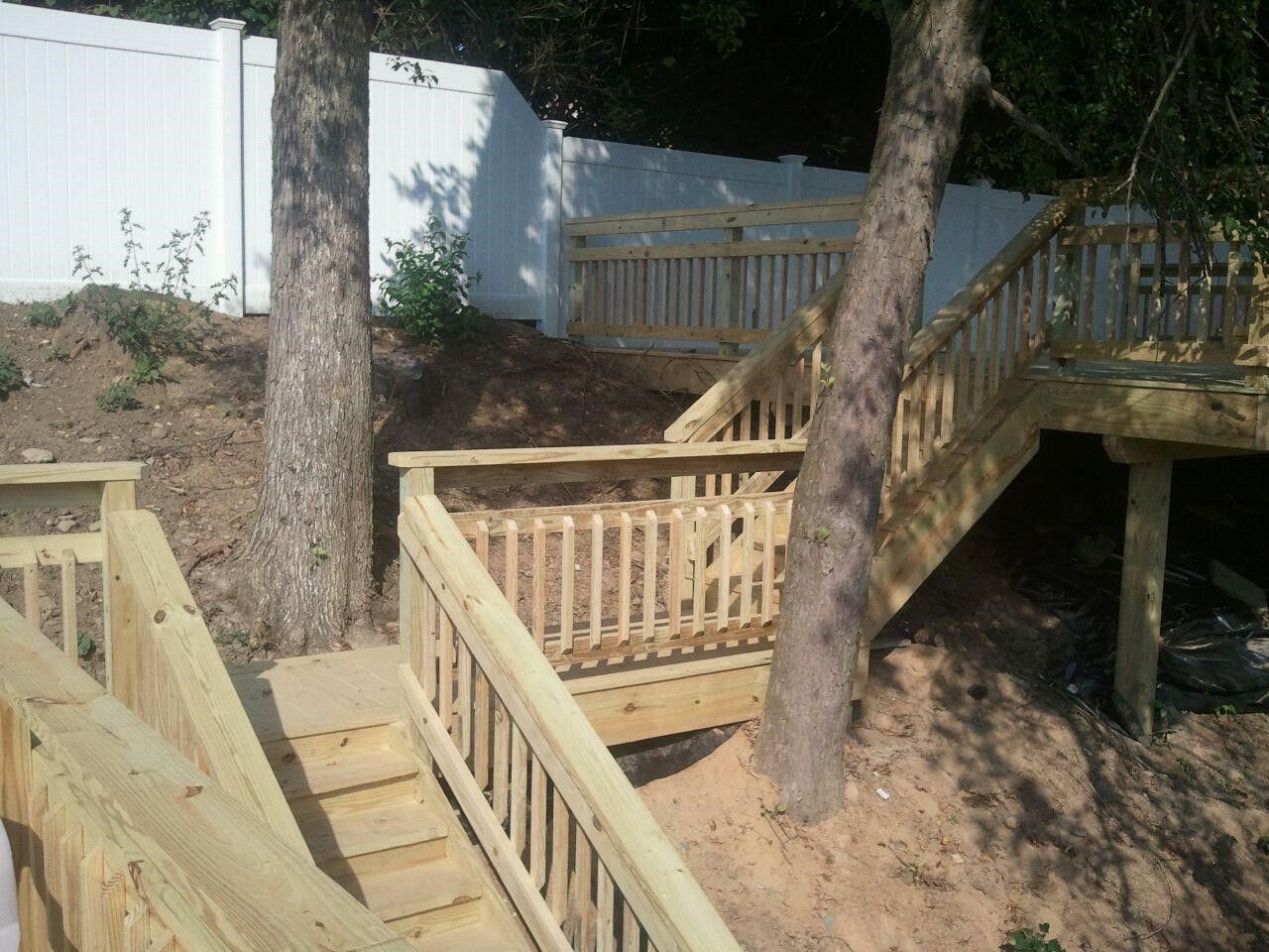 A wooden deck with stairs leading up to it