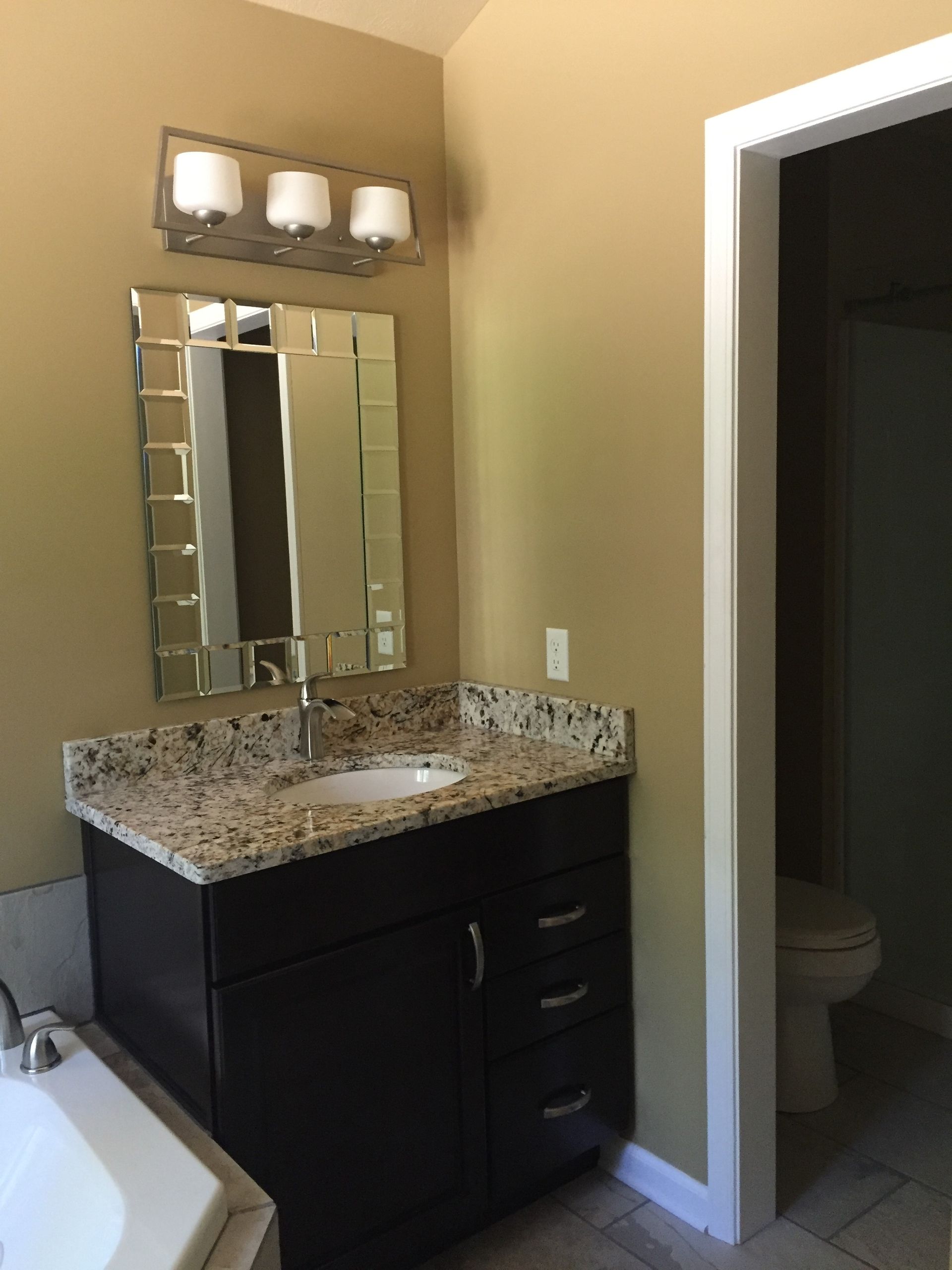A bathroom with a sink a mirror and a tub
