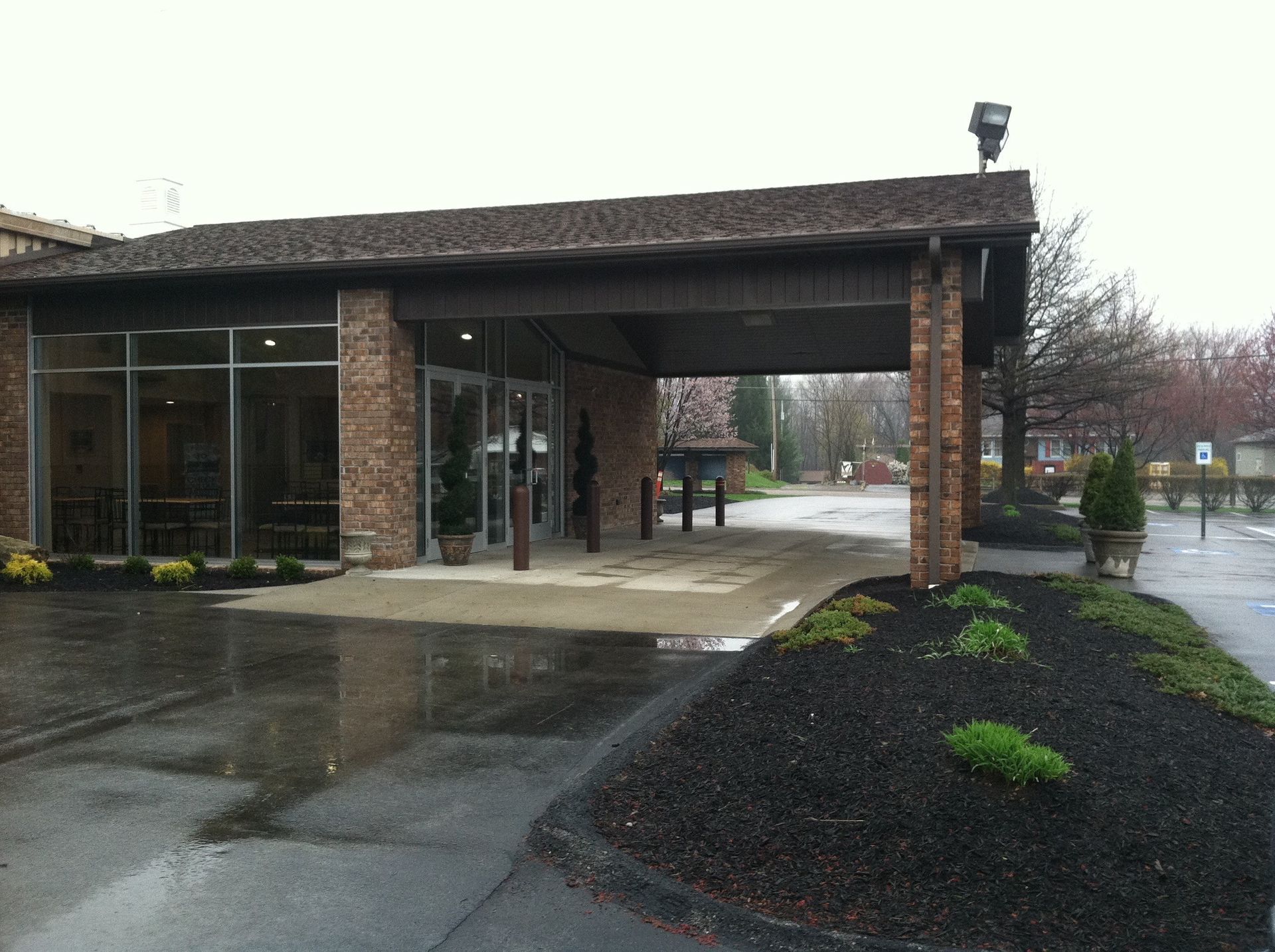 A brick building with a parking lot in front of it