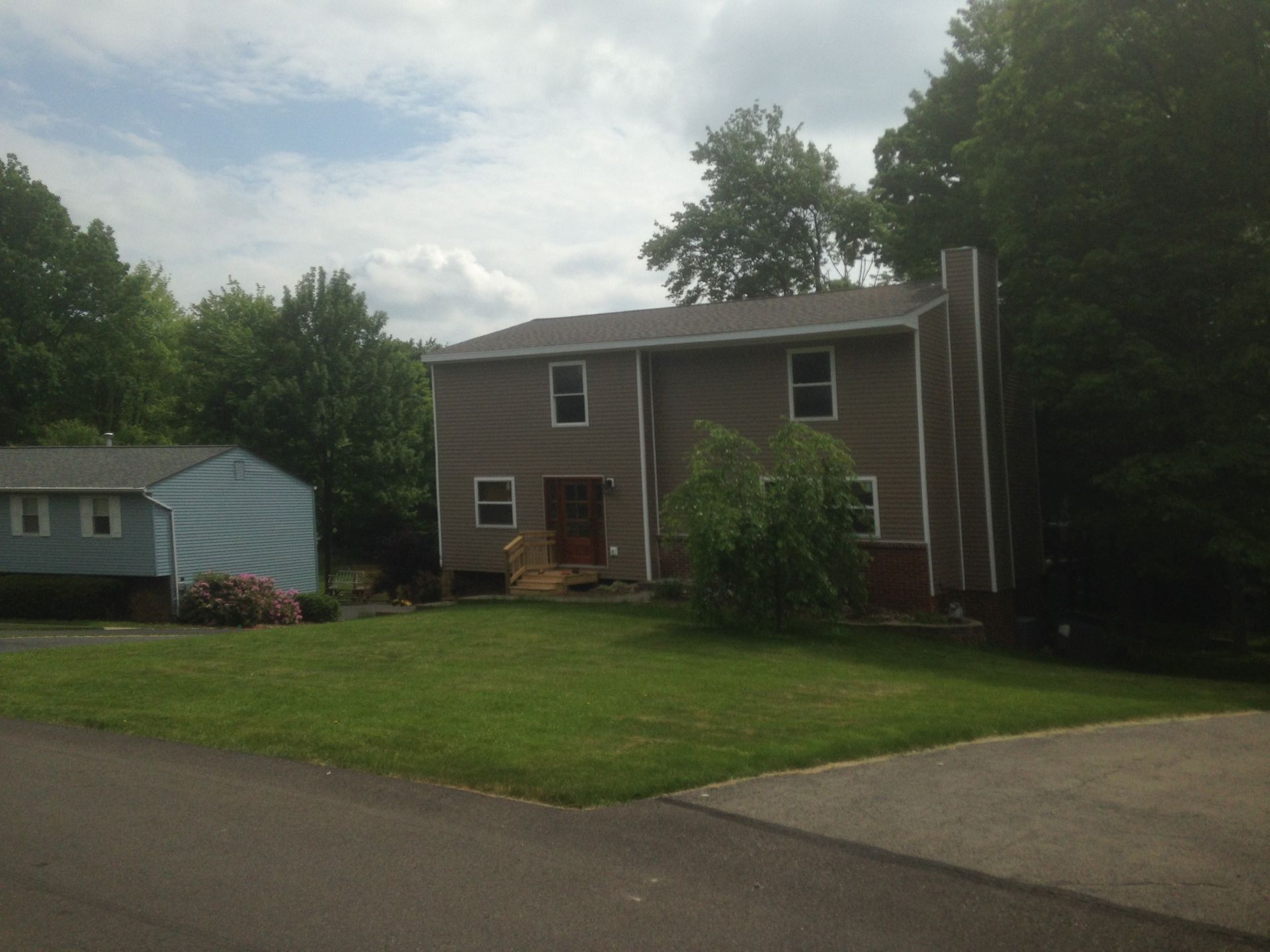 A house with a large lawn in front of it