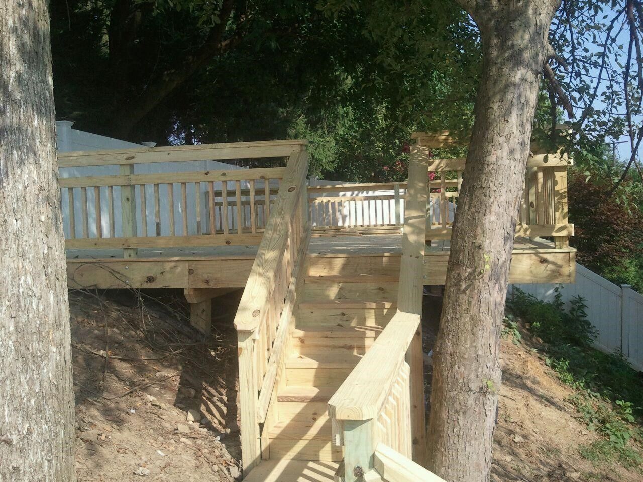 A wooden deck with stairs leading up to it