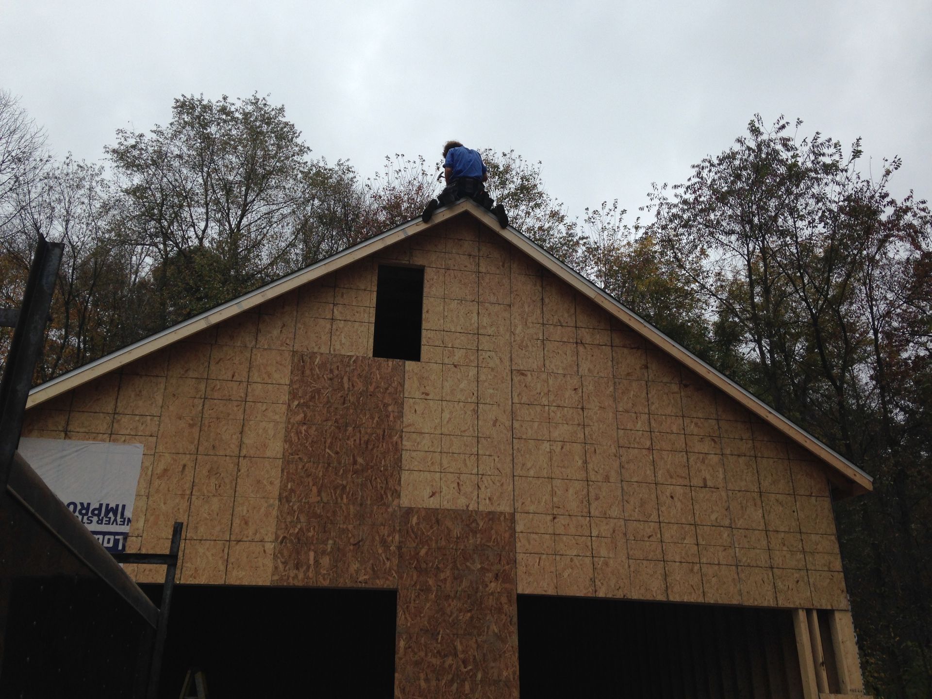 A man is working on the roof of a house