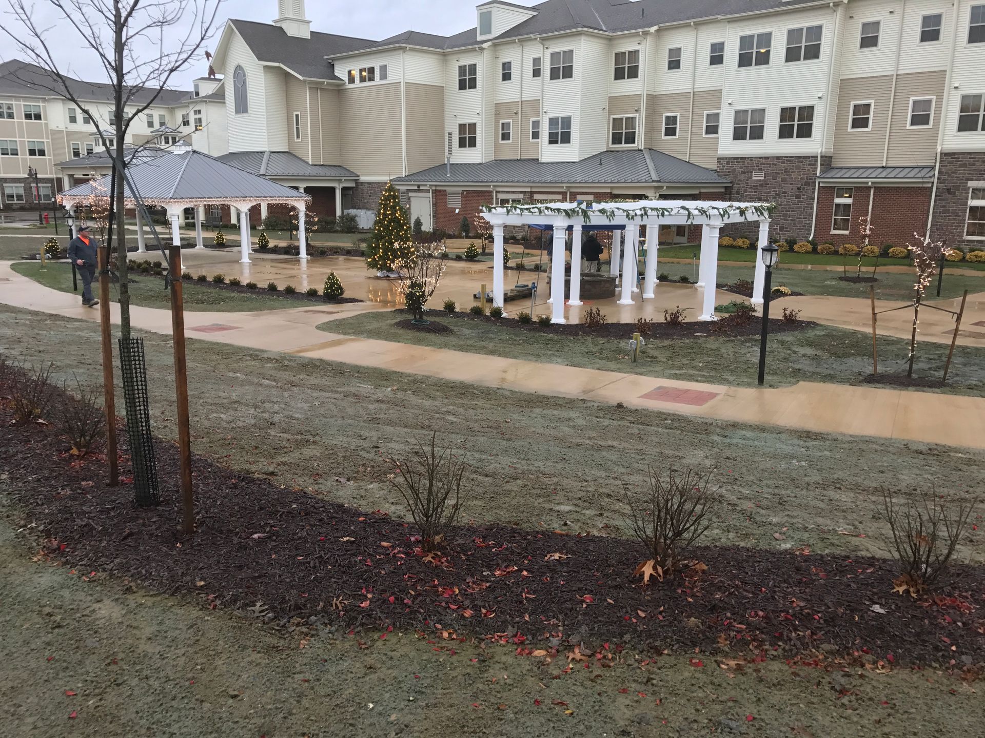 A large apartment building with a pergola in front of it.