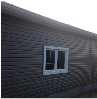Gray siding on a building with a white-framed window.