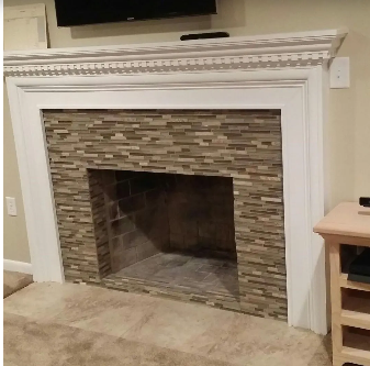 Fireplace with stone tile surround, white trim, and a decorative mantel.