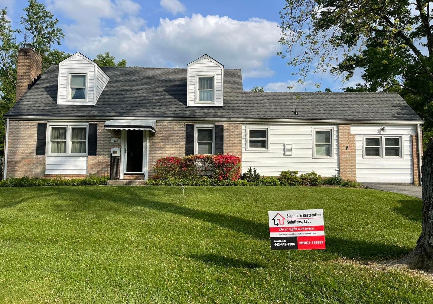 A house with a for sale sign in front of it
