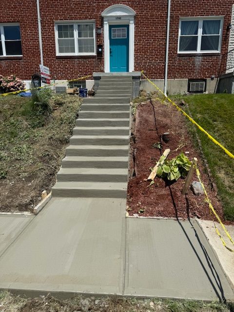 A set of stairs leading up to a house with a blue door.