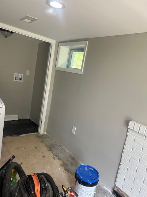 A laundry room with a washer and dryer and a window.