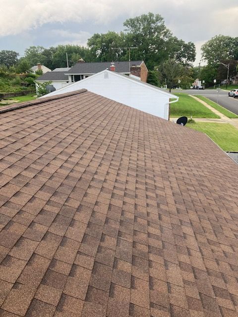 A house with a brown roof and a white chimney
