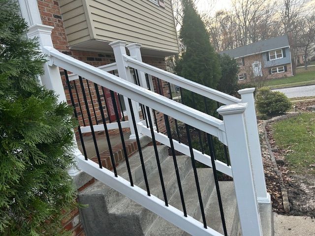 A white railing on the stairs of a house