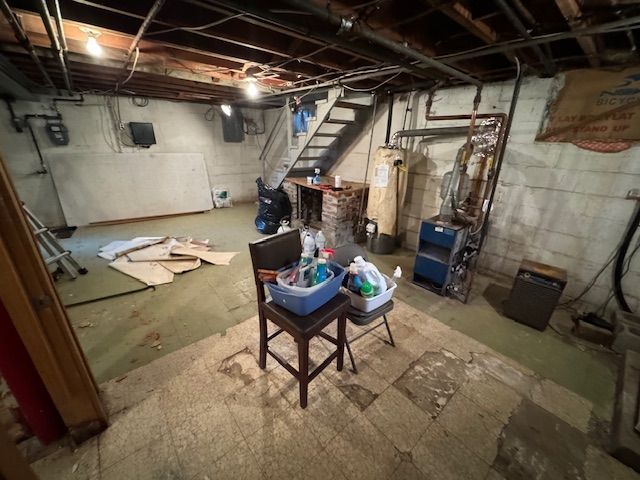 A basement with a staircase and a chair in it