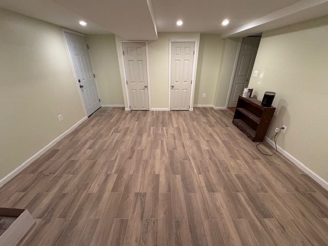 A room with hardwood floors and white walls