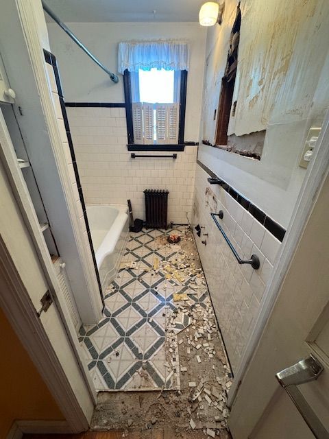 A bathroom with a bathtub and a window is being remodeled.