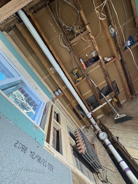 A room with a lot of pipes hanging from the ceiling