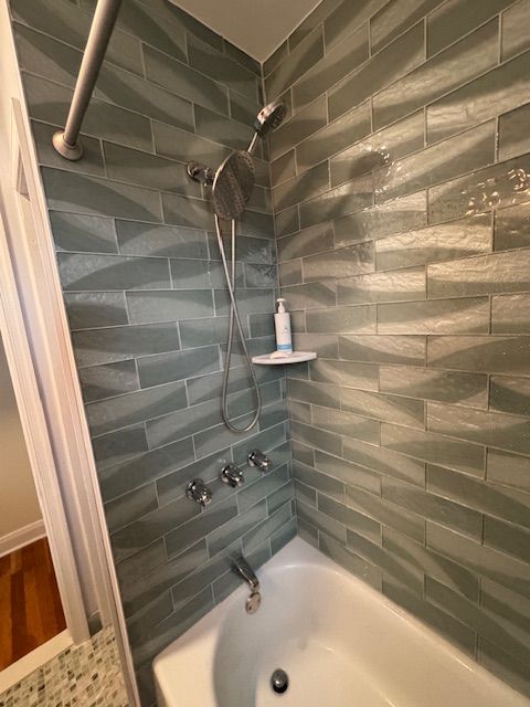 A bathroom with a bathtub and a shower.