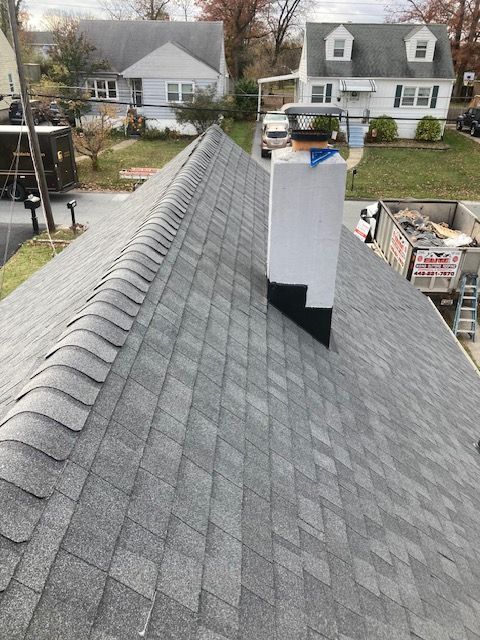 A gray roof with a chimney on top of it