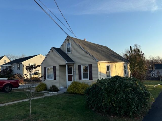A house with new roof and a red truck parked in front of it