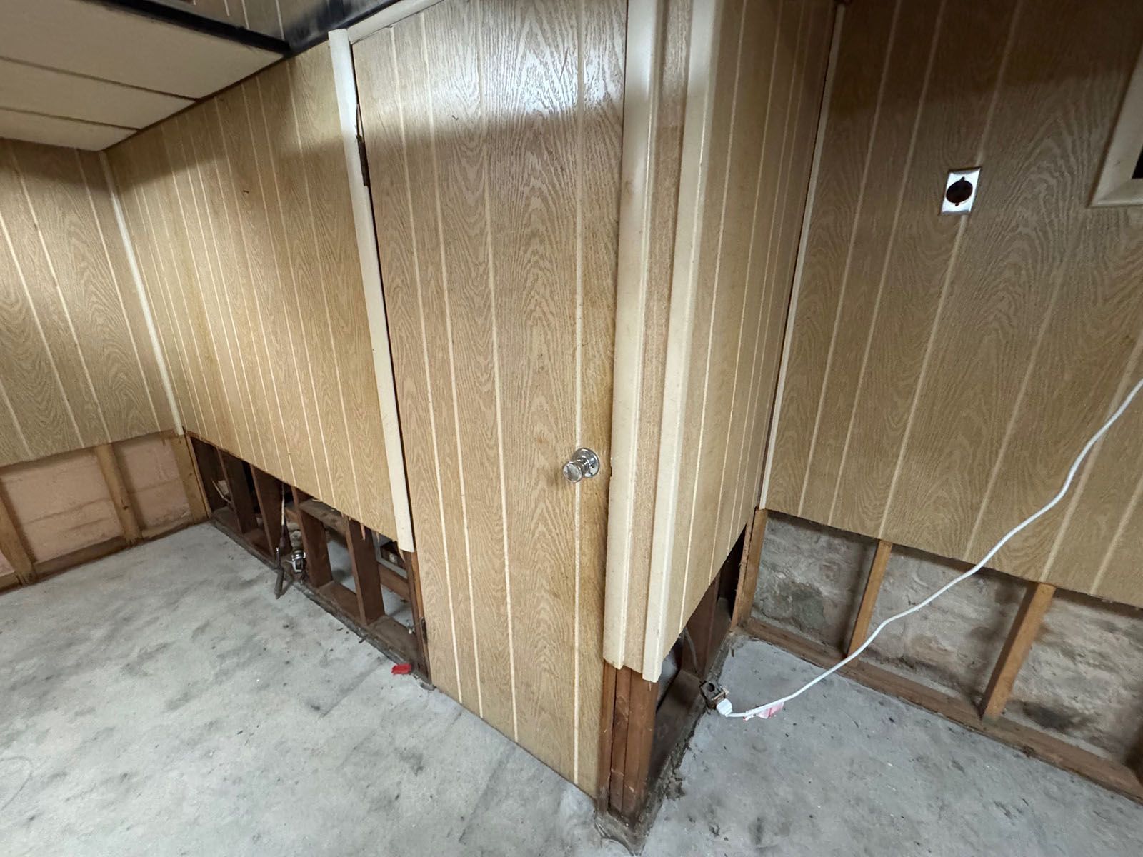 A damaged room with wooden panels