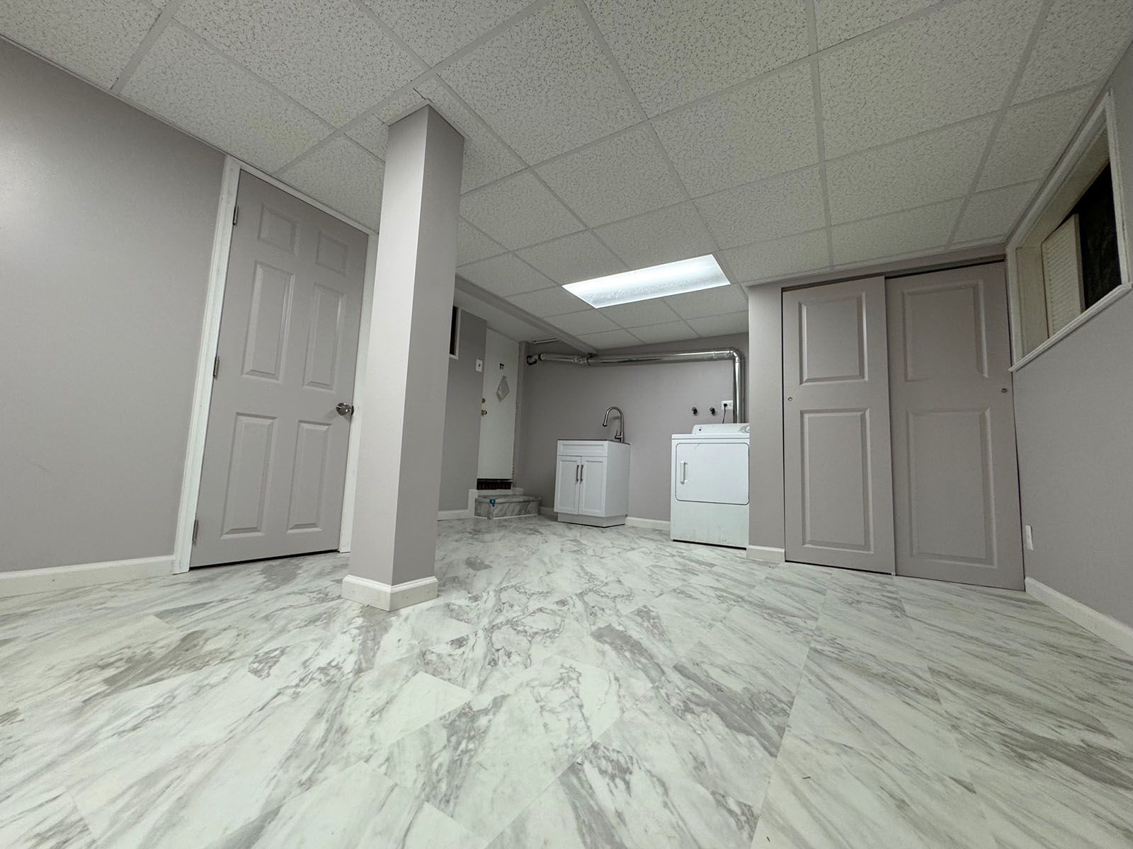 A laundry room with a marble floor