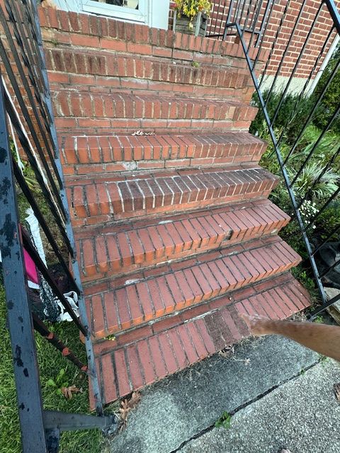 Brick exterior steps with metal railing.