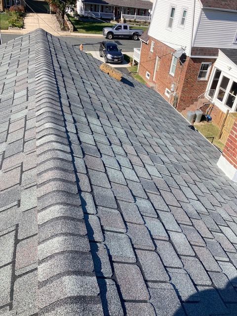 Gray asphalt shingle roof on a residential building, angled view.