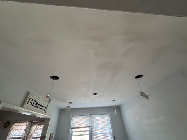 White ceiling with recessed lighting holes; 