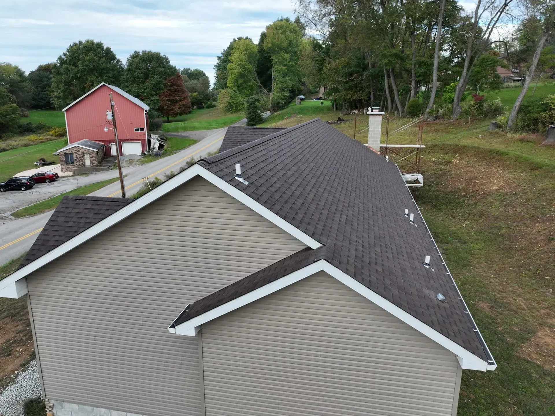 An aerial view of a house with a new roof.