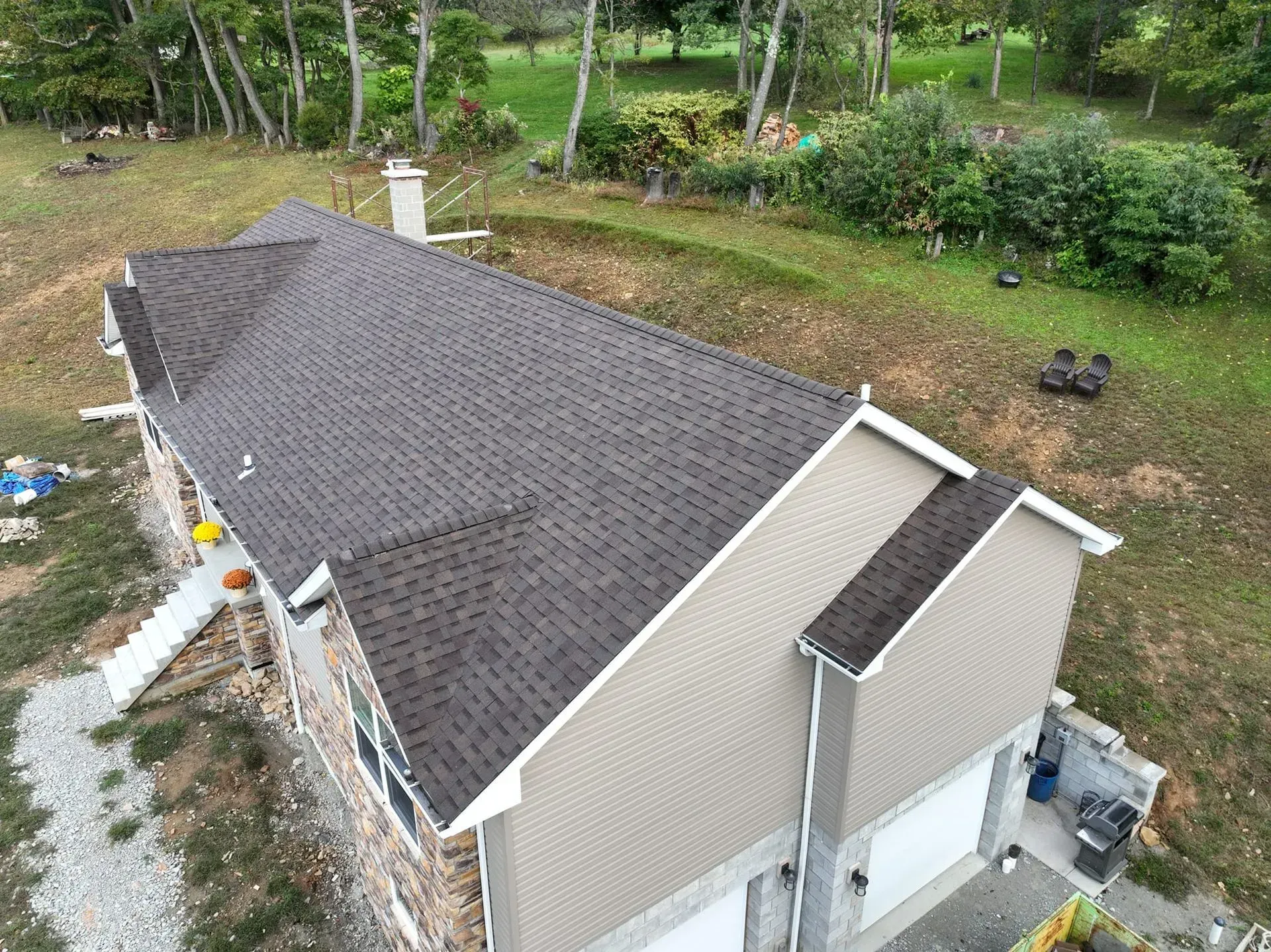 An aerial view of a house with a new roof.