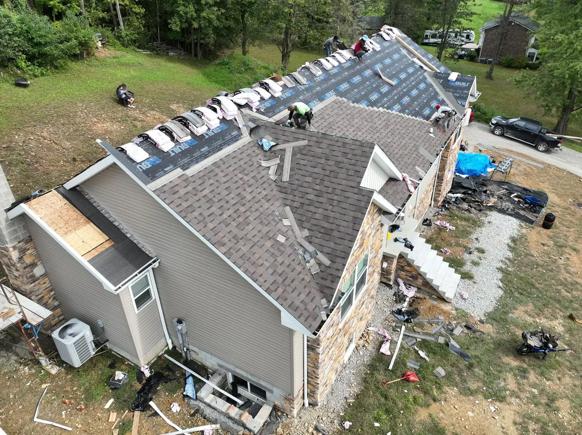 An aerial view of a house being remodeled with a new roof.
