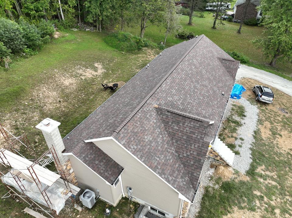An aerial view of a house with a new roof.
