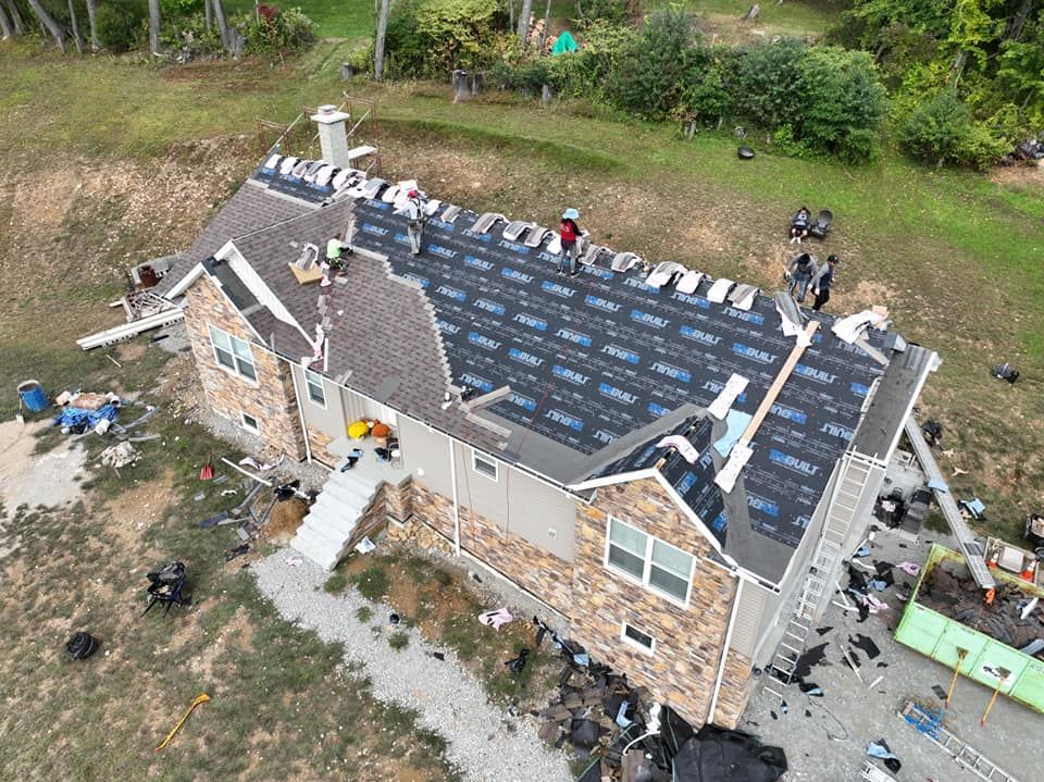 An aerial view of a house undergoing a roof replacement.
