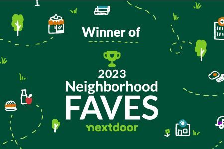 A green sign that says winner of neighborhood faves nextdoor