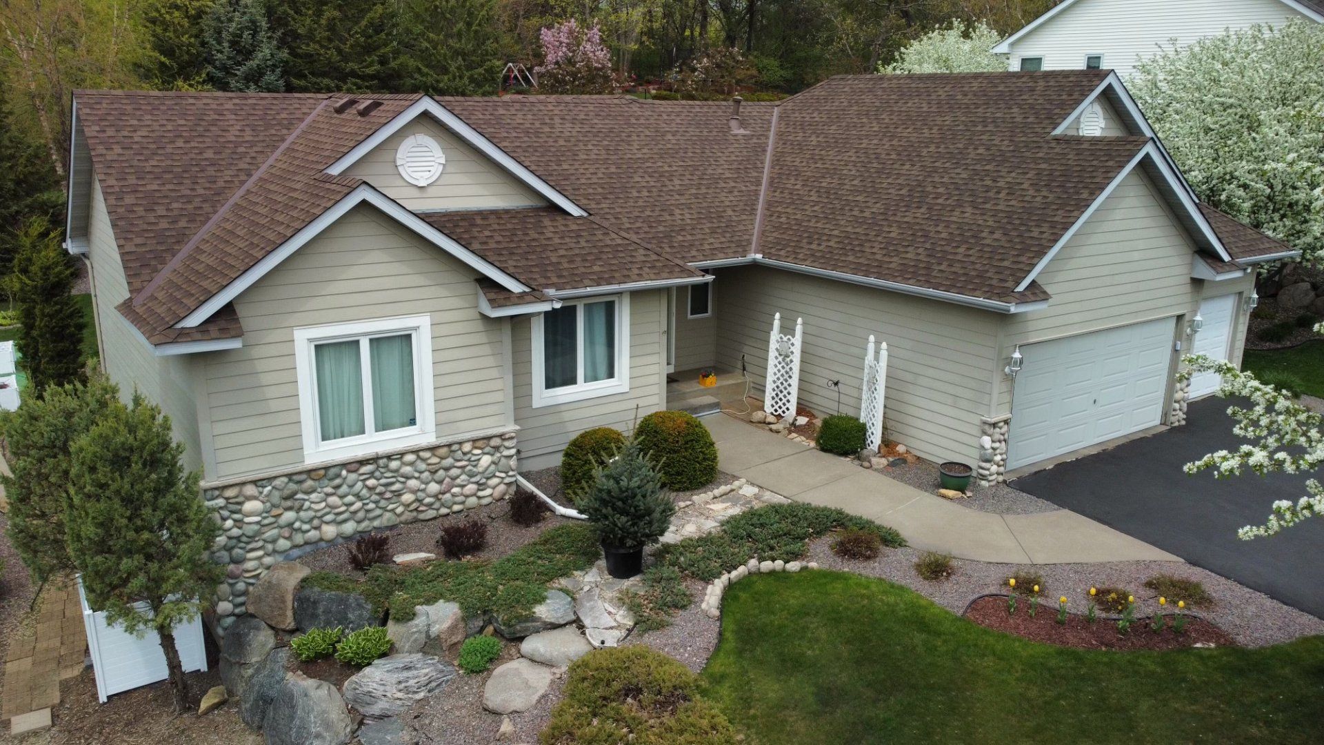 An aerial view of a house with a brown roof