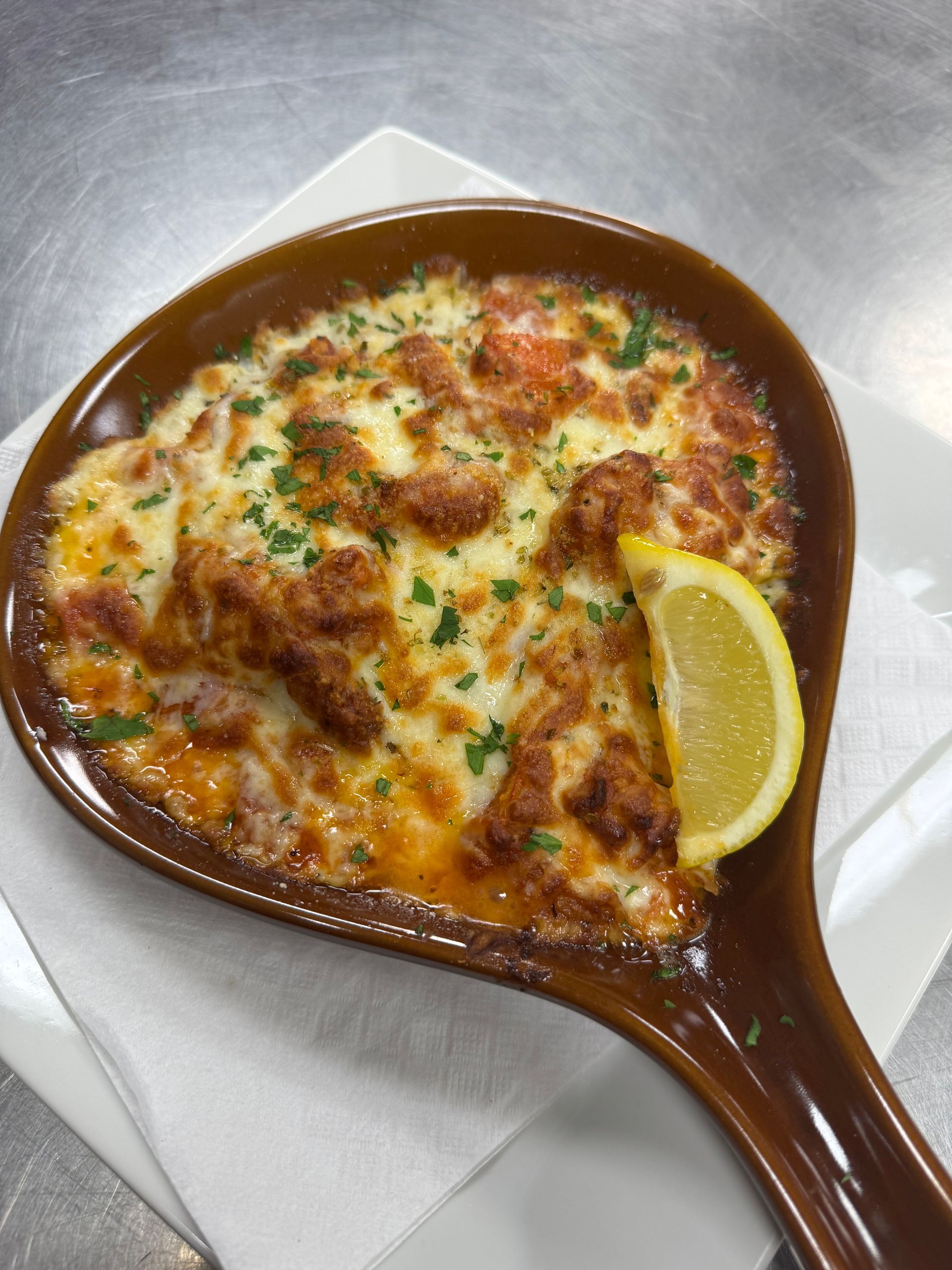 A casserole dish with a slice of lemon on top