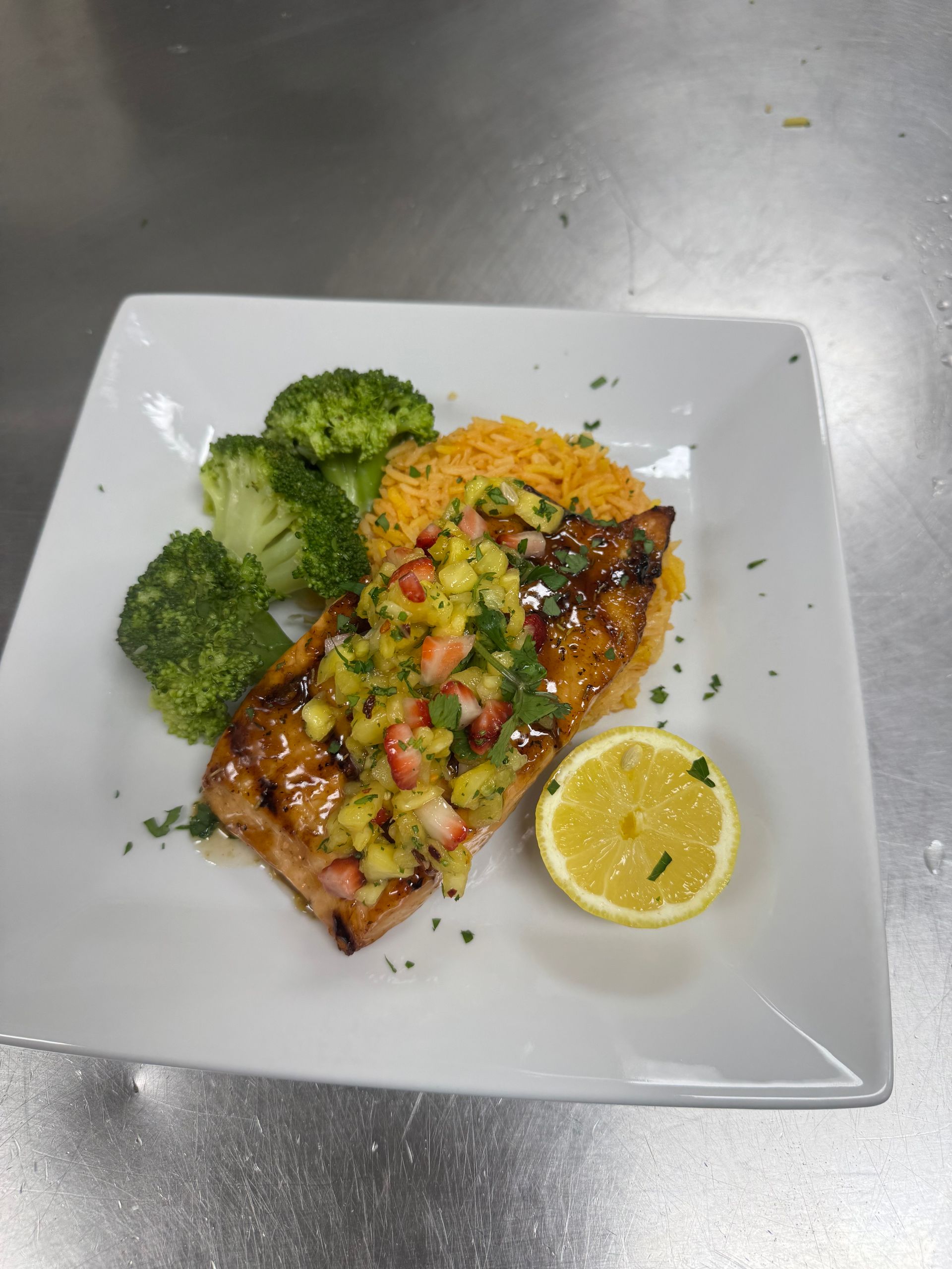 A plate of food with broccoli and rice on a table